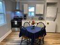 Eat in kitchen features stainless steel appliances, a window over the sink, and laminate floors at 416 S Magnolia Ave., Andrews, SC 29510