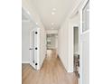 Bright hallway featuring hardwood floors, crown molding, and access to other rooms in the house at 7076 Denim Loop, Myrtle Beach, SC 29579