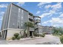 Attractive condominium with multi-level balconies and private entrances surrounded by lush landscaping at 1101 Possum Trot Rd. # B302, North Myrtle Beach, SC 29582