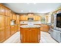 Well-equipped kitchen with an island, wooden cabinets, and stainless steel appliances at 244 George Washington Trail, Georgetown, SC 29440