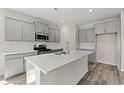 Well-lit kitchen with stainless steel appliances, white countertops, tiled backsplash, and large center island at 3344 Little Bay Dr., Conway, SC 29526