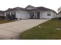 Attractive single-level home featuring a spacious driveway and a well-maintained lawn at 237 Cloverleaf Dr., Longs, SC 29568