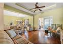 Cozy living room with hardwood floors, ceiling fan and adjacent dining area with lots of natural light at 237 Cloverleaf Dr., Longs, SC 29568