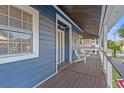 Upstairs porch with wooden flooring and white chairs at 508 21St Ave. N, North Myrtle Beach, SC 29582