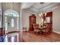 Open dining room with hardwood floors, tray ceiling, and views of the front foyer at 8556 Juxa Dr., Myrtle Beach, SC 29579