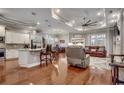 Open concept living room and kitchen space with hardwood flooring and comfortable seating at 8556 Juxa Dr., Myrtle Beach, SC 29579