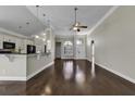 Open living area with hardwood floors and a view of the kitchen at 217 Southern Breezes Circle, Murrells Inlet, SC 29576
