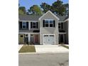 These newly constructed townhomes showcase attached garages, tidy landscaping, and modern designs at 259 Christiana Ln. # E, Myrtle Beach, SC 29579
