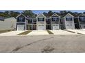 A row of charming townhomes with attached garages offers modern living and curb appeal at 259 Christiana Ln. # E, Myrtle Beach, SC 29579