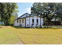 Beautifully landscaped home featuring a white exterior and a well-manicured lawn at 37 Geney Ln., Pawleys Island, SC 29585