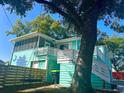 Beautiful turquoise home featuring a spacious deck, swing, and a unique coastal vibe at 3936 Murrells Inlet Rd., Murrells Inlet, SC 29576