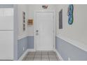 Entryway view with white door, neutral flooring, and chair rail at 4879 Dahlia Ct. # 204, Myrtle Beach, SC 29577