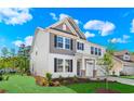 Elegant two-story home featuring a two-car garage and lush landscaped yard at 5024 Cambria Ct., Little River, SC 29566