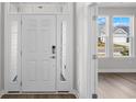 Bright entryway featuring a white front door with sidelights and a transom window at 5024 Cambria Ct., Little River, SC 29566