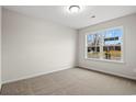 Bright bedroom with neutral walls and carpet flooring, featuring a large window at 902 Owls Nest Dr., Conway, SC 29527