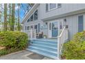 Inviting front porch with blue paint, white railings, and comfy seating at 163 Parkview Dr., Pawleys Island, SC 29585