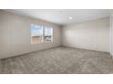 Spacious bedroom with neutral carpet and large window at 218 Eva Dr., Loris, SC 29569