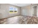 Living room with wood-look floors and accent wall at 218 Eva Dr., Loris, SC 29569