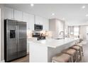 Open kitchen with stainless steel appliances, quartz counters, and a large island with seating at 2050 Nw Parow Ln Nw # E, Calabash, NC 28467
