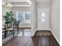 Bright entryway featuring wood-look flooring, decorative rug, and a white door, creating an inviting and stylish entrance at 2327 King Farm Rd., Aynor, SC 29511