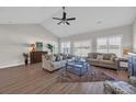 Spacious living room with vaulted ceilings, hardwood floors, neutral furniture, and large windows providing plenty of natural light at 2327 King Farm Rd., Aynor, SC 29511
