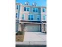 A townhouse showcasing stone and siding, a garage, and a well-kept lawn at 2557 7B Pete Dye Dr. # 704, North Myrtle Beach, SC 29582