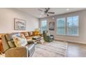 Bright living room with a leather sofa, recliners, ceiling fan, and large windows for natural light at 2557 7B Pete Dye Dr. # 704, North Myrtle Beach, SC 29582