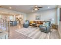 Open-concept living room featuring wood floors, comfortable seating, and ample natural light at 2557 7B Pete Dye Dr. # 704, North Myrtle Beach, SC 29582
