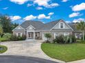 Lovely brick home with a sprawling driveway, beautifully landscaped yard, and classic architectural details at 116 Ocean Sands Ct., Myrtle Beach, SC 29579