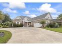 Inviting brick home featuring a spacious driveway, lush lawn, and well-maintained landscaping at 116 Ocean Sands Ct., Myrtle Beach, SC 29579