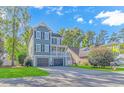 Lovely two-story house with a double garage, complemented by a well-maintained front yard at 136 Kenzgar Dr., Myrtle Beach, SC 29588