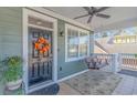 Inviting front porch with a swing and seasonal decor creating a cozy outdoor space at 136 Kenzgar Dr., Myrtle Beach, SC 29588