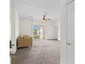 Bright, carpeted living room with neutral walls, ceiling fan, and access to balcony at 2241 Waterview Dr. # 437, North Myrtle Beach, SC 29582