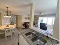 Kitchen with granite countertops, looking toward dining and living areas at 2268 Essex Dr. # G, Surfside Beach, SC 29575