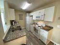 Well-equipped kitchen, white cabinets, and granite countertop at 2268 Essex Dr. # G, Surfside Beach, SC 29575