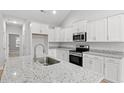 Well-lit modern kitchen with granite countertops, stainless steel appliances, and white cabinets at 608 Britt St., Georgetown, SC 29440