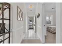 Inviting foyer with tile flooring, mirrored accent, coat rack and view of a bedroom and outdoor scenery at 703 Riverwalk Dr. # 304, Myrtle Beach, SC 29579