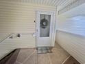 A welcoming front door with a wreath and 'welcome' mat on a covered porch at 8830 Chandler Dr. # G, Surfside Beach, SC 29575