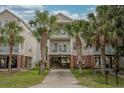 Charming coastal home with multiple balconies supported by stilts, surrounded by palm trees at 118A 6Th Ave. N, Surfside Beach, SC 29575