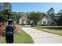 Beautiful home with a long driveway, mature trees, and inviting curb appeal at 1716 Club Circle Dr., Pawleys Island, SC 29585