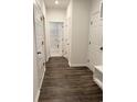 Hallway with wood flooring featuring closet and doorway to laundry room at 8640 Farrier Dr., Myrtle Beach, SC 29588