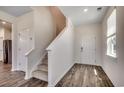 Inviting foyer featuring wood-look flooring, staircase, and natural light at 8648 Farrier Dr., Myrtle Beach, SC 29588