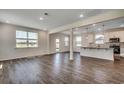 Open-concept living room with wood-look floors, neutral walls, and lots of natural light at 8648 Farrier Dr., Myrtle Beach, SC 29588