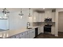 Bright kitchen featuring stainless steel appliances, quartz countertops, stylish backsplash, and pendant lights at 8652 Farrier Dr., Myrtle Beach, SC 29588