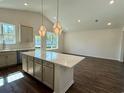 Well-lit kitchen with a large island, stainless steel appliances, and ample counter space at 8663 Farrier Dr., Myrtle Beach, SC 29588