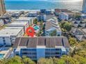 Aerial view showcasing a coastal condo complex with a pool, proximate beaches, ocean views and surrounding neighborhood at 9581 Shore Dr. # 132, Myrtle Beach, SC 29572