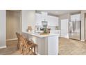 Modern kitchen with stainless steel appliances, a breakfast bar, and white cabinetry at 4009 Braid Ct., Myrtle Beach, SC 29588