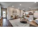 Open-concept living room with modern furnishings and a seamless flow into the kitchen and dining area at 4009 Braid Ct., Myrtle Beach, SC 29588