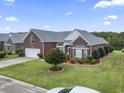 Expansive brick home with lush landscaping and a sprawling lawn for outdoor enjoyment at 1066 Brentford Pl., Myrtle Beach, SC 29579