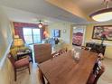 Bright living space with comfortable furniture, balcony access and an adjacent dining area at 2007 S Ocean Blvd. # 401, Myrtle Beach, SC 29577